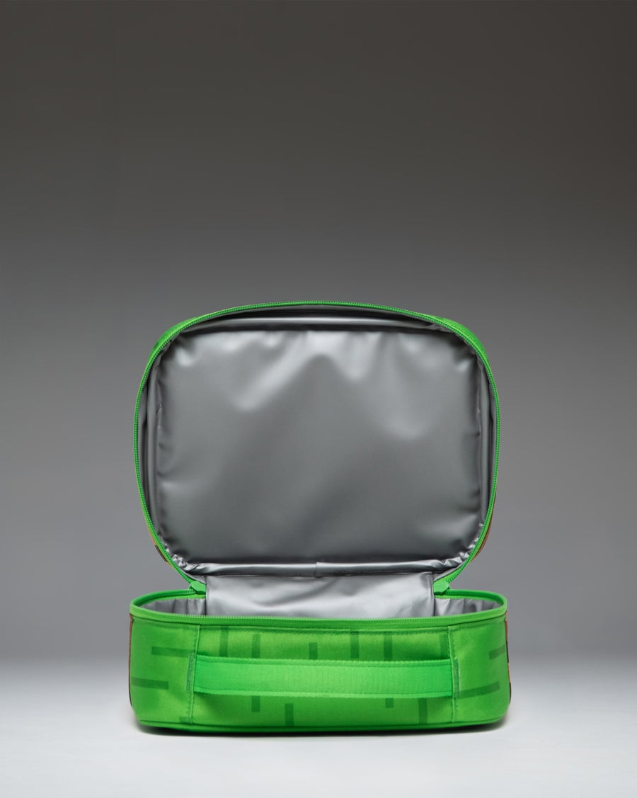 Herschel Supply Co. Minecraft Pop Quiz Lunch Box in The Overworld print, featuring a pixelated grass and dirt block design.