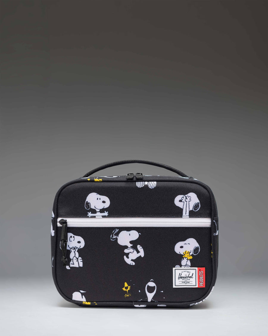 Herschel Supply Co. Peanuts Pop Quiz Lunch Box in Snoopy and Woodstock Black featuring a repeating pattern of Snoopy sleeping on his doghouse.