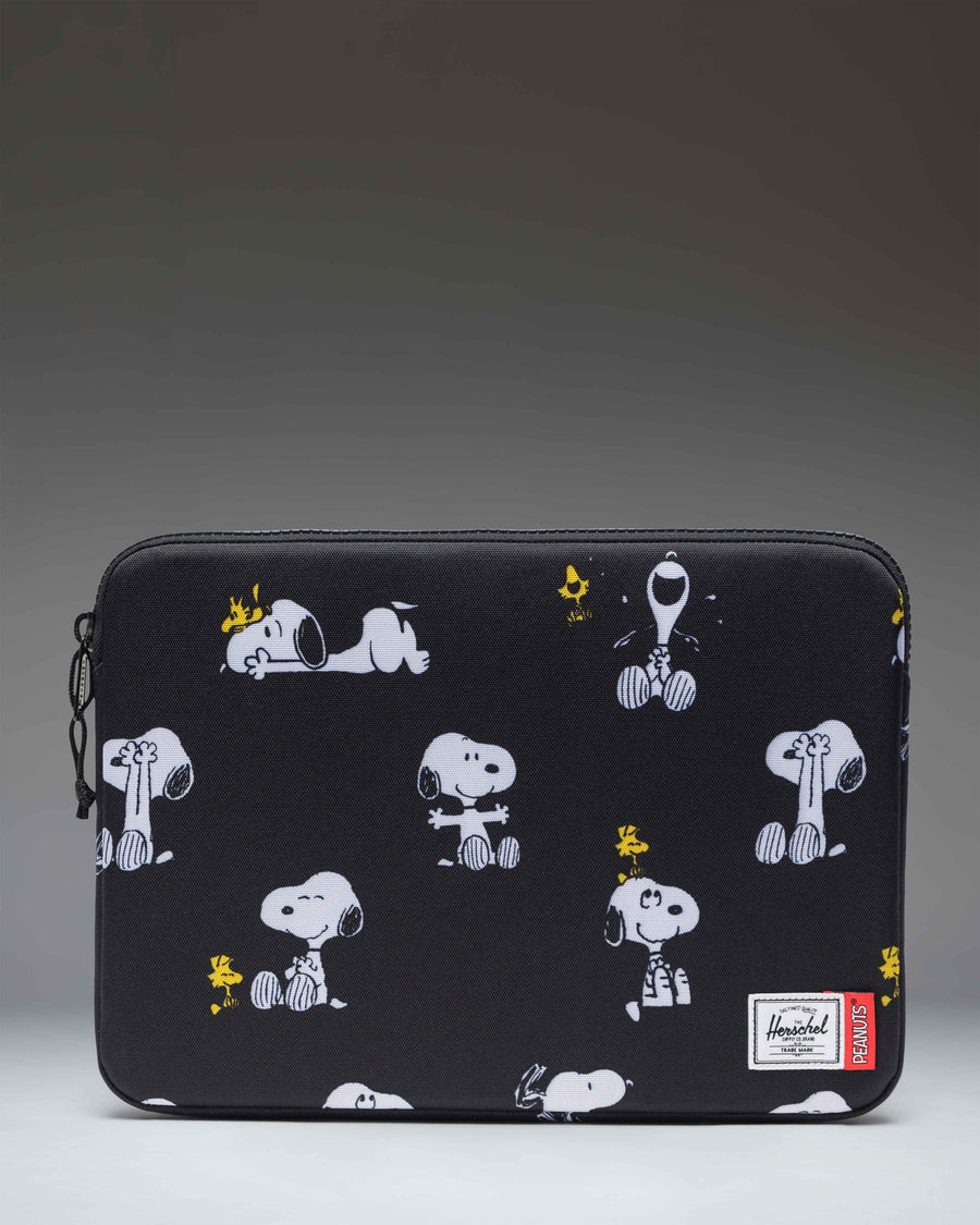 Herschel Supply Co. Peanuts Anchor 14 Inch Sleeve in Snoopy and Woodstock Black, featuring a repeating print of Snoopy and Woodstock.