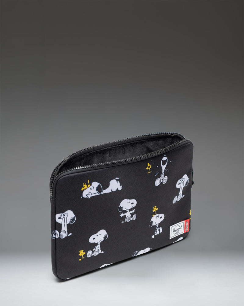Herschel Supply Co Peanuts Anchor 14 Inch Laptop Sleeve in Snoopy and Woodstock Black pattern.