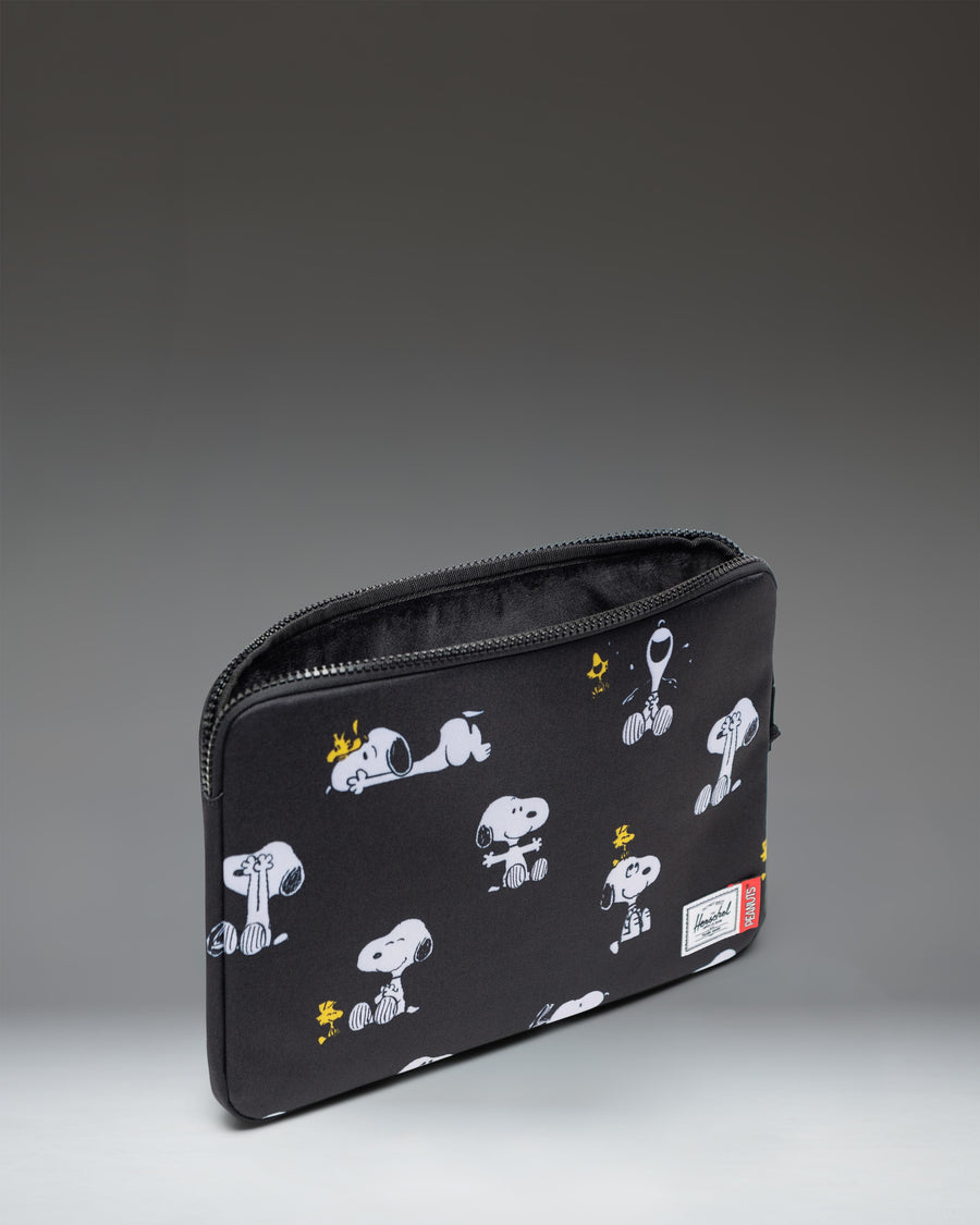 Herschel Supply Co Peanuts Anchor 14 Inch Laptop Sleeve in Snoopy and Woodstock Black pattern.