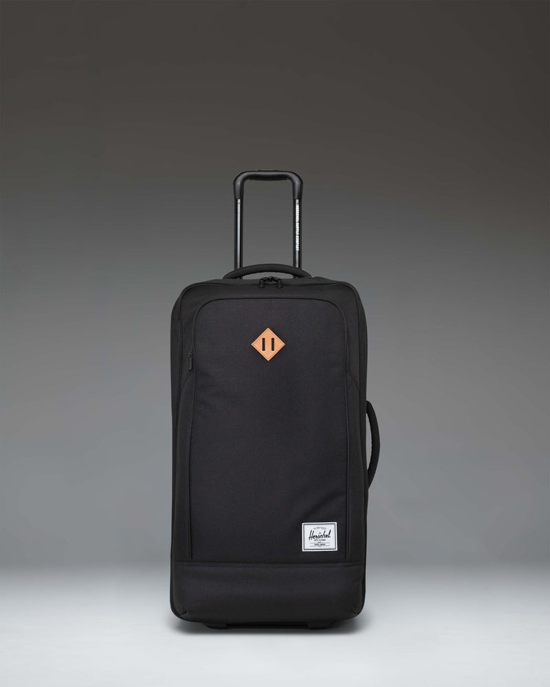 Herschel Heritage Softshell Medium Luggage in black, showing an oversized view of the front exterior fabric, zipper, and subtle tonal branding.