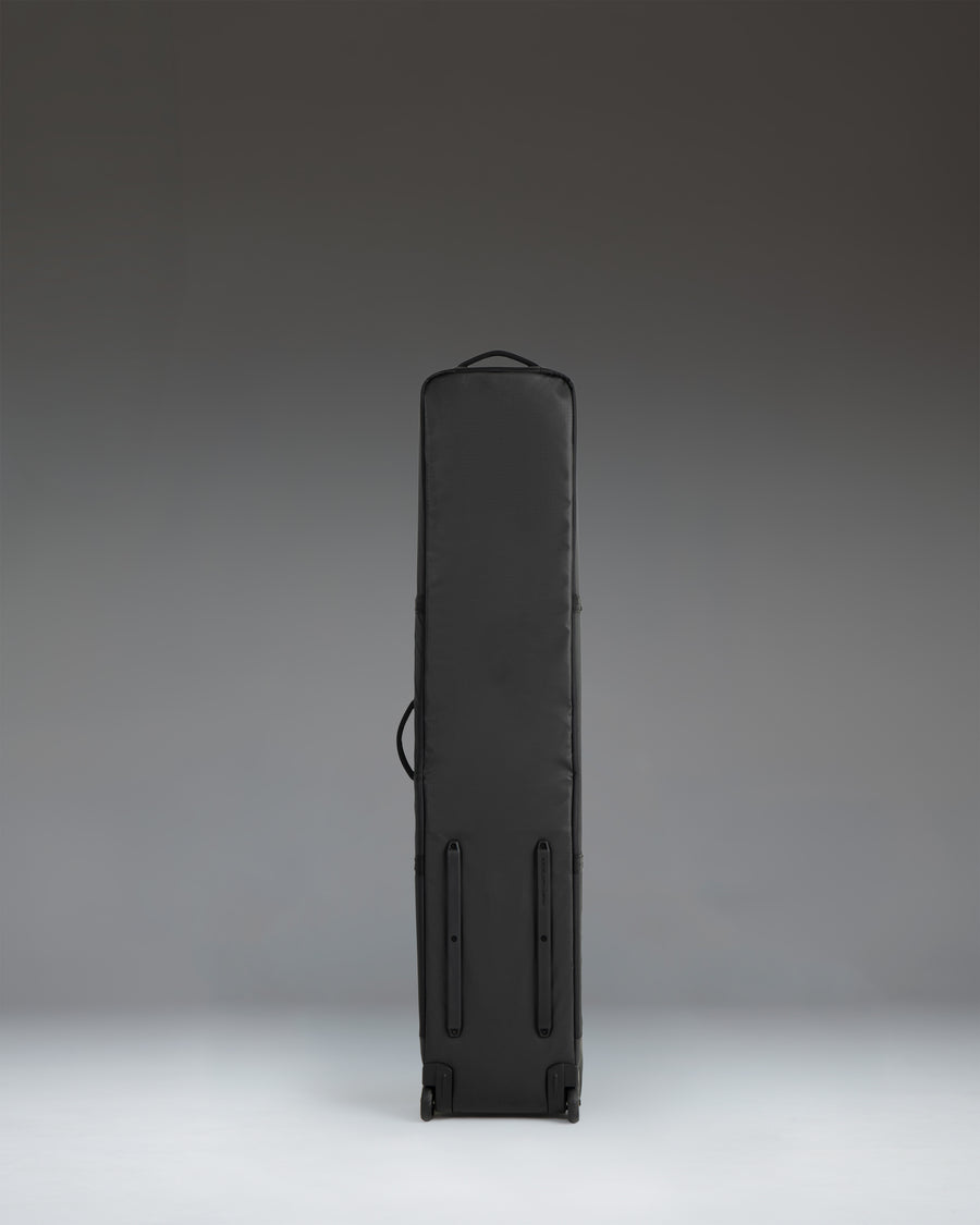 Herschel Supply Co. Snow Roller Bag 158cm in black, shown from the side with durable wheels and a carrying handle.