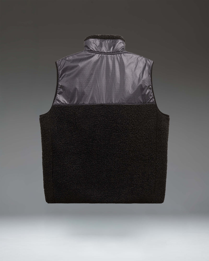 Herschel Supply Co. Men's Performance Fleece Vest in solid black featuring a full-zip front and a zippered chest pocket.