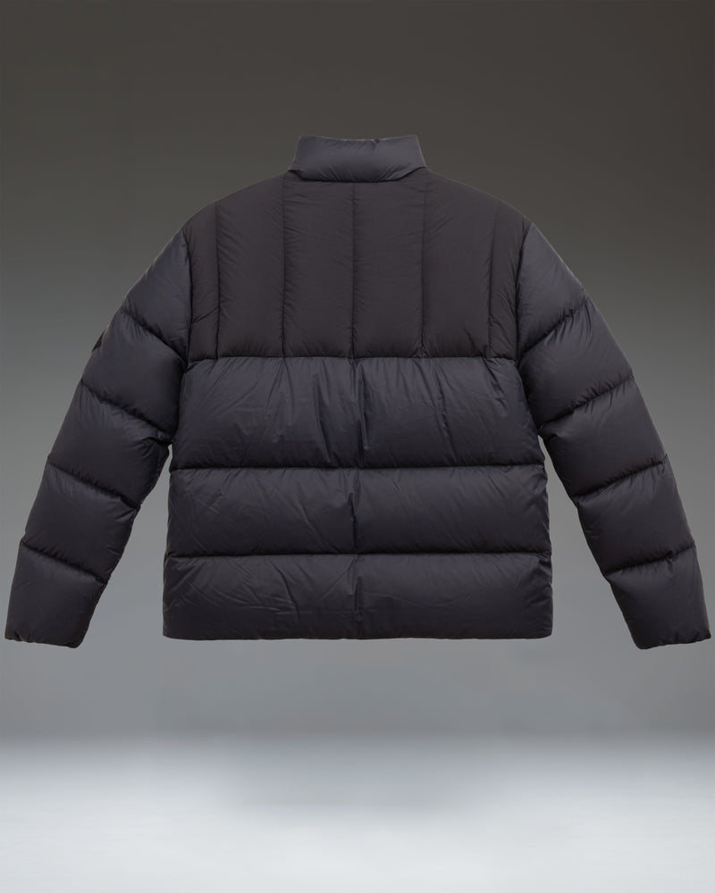 Herschel Supply Co. men's black puffer jacket featuring a quilted design, full front zipper, high collar, and a subtle brand logo on the chest.