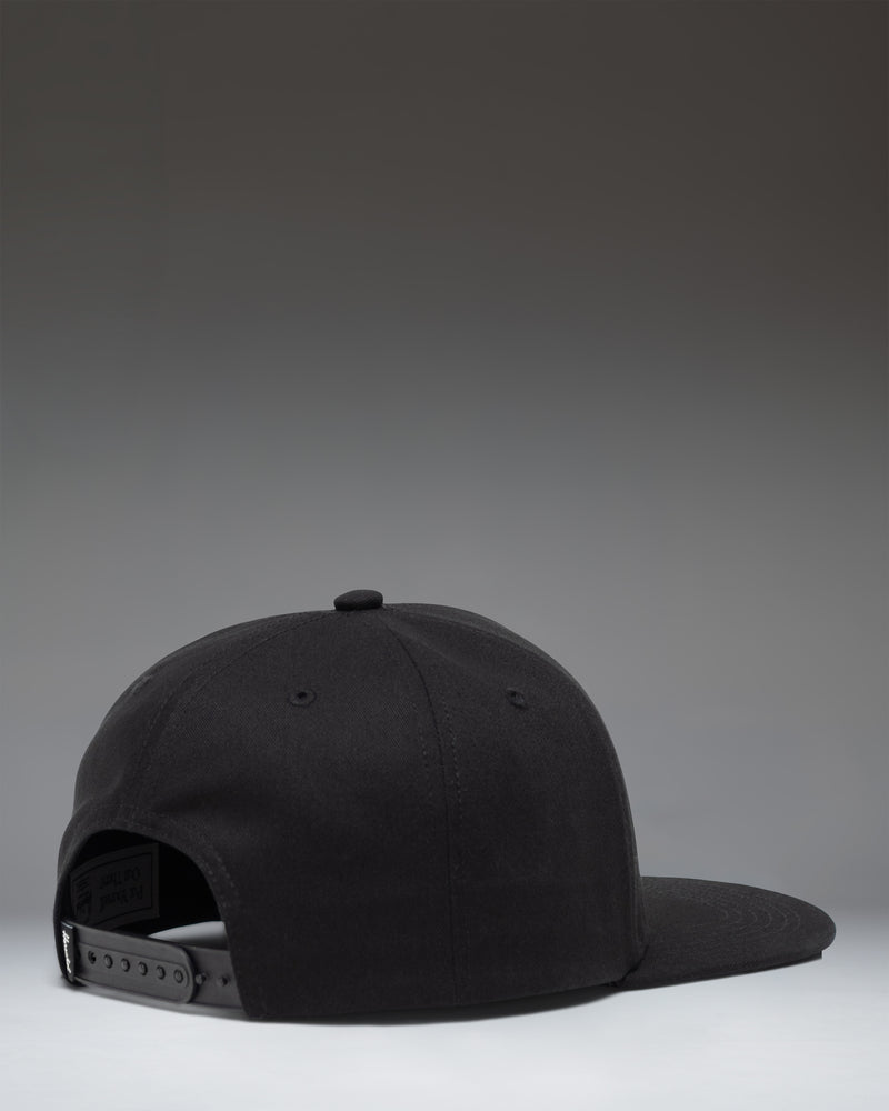 Herschel Supply Co. Whaler 6 Panel Cap in black, featuring a structured crown, flat brim, and an adjustable snapback closure.