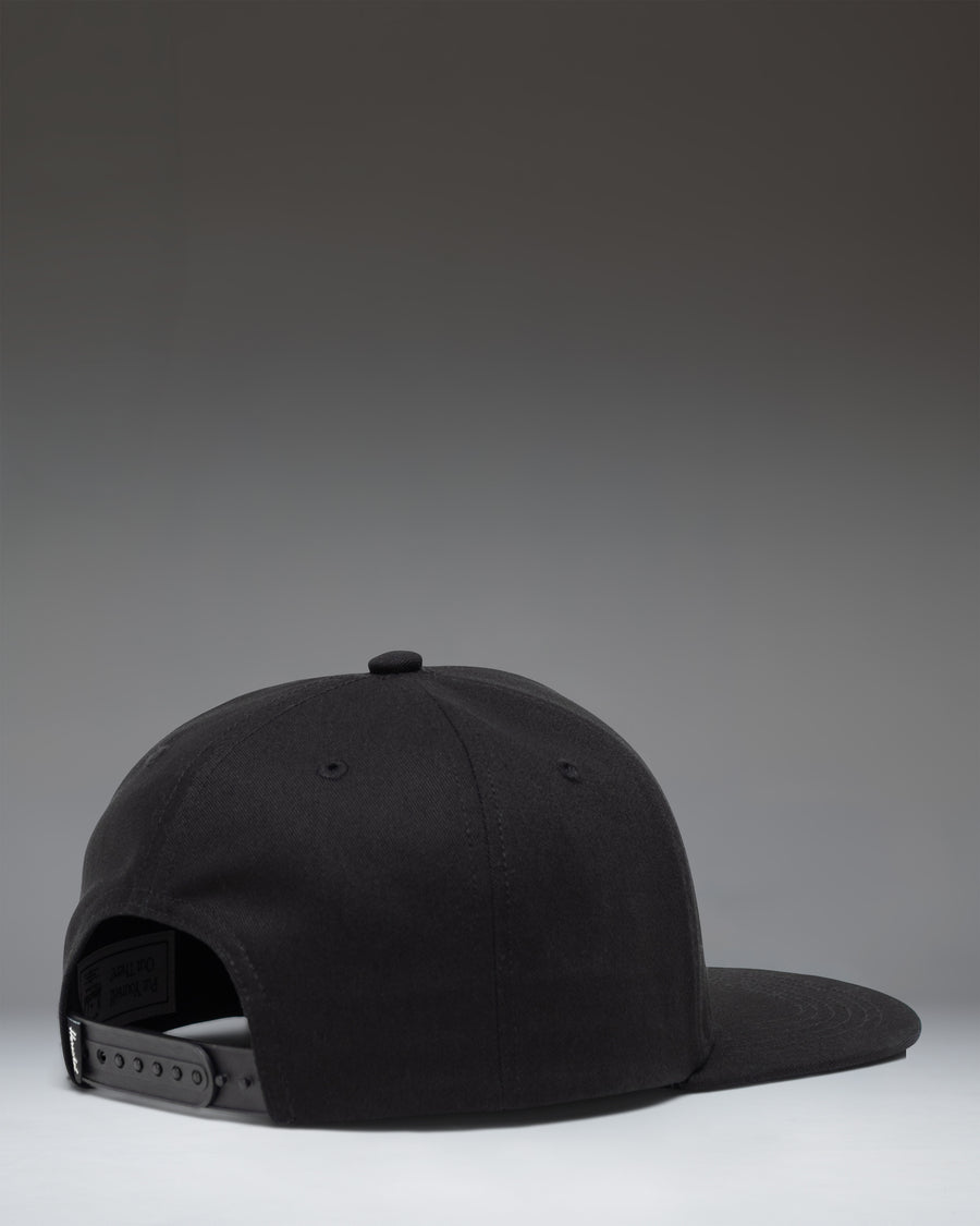 Herschel Supply Co. Whaler 6 Panel Cap in black, featuring a structured crown, flat brim, and an adjustable snapback closure.