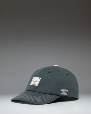 Herschel Supply Co Sylas Premium Cap in Green Gables dark green with vintage white stitching.
