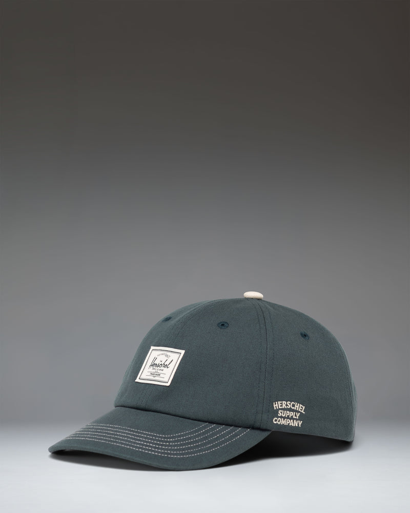 Herschel Supply Co Sylas Premium Cap in Green Gables dark green with vintage white stitching.