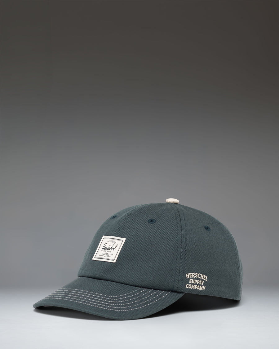 Herschel Supply Co Sylas Premium Cap in Green Gables dark green with vintage white stitching.