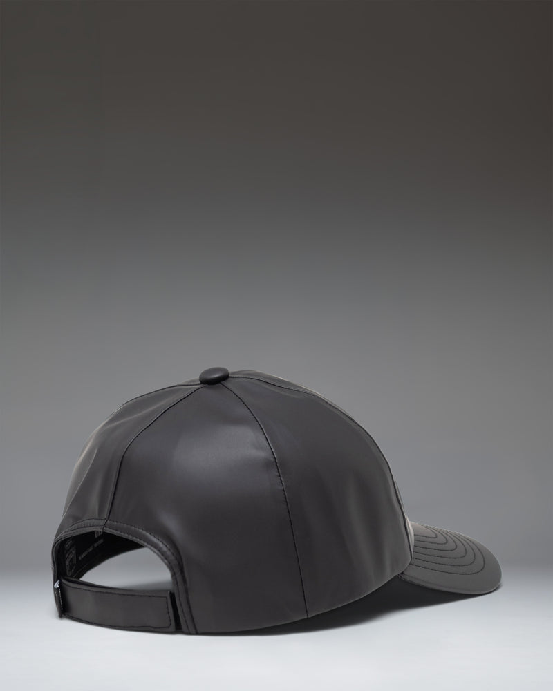 Herschel Supply Co Sylas Rain Cap in black, showing the side profile and adjustable strap.