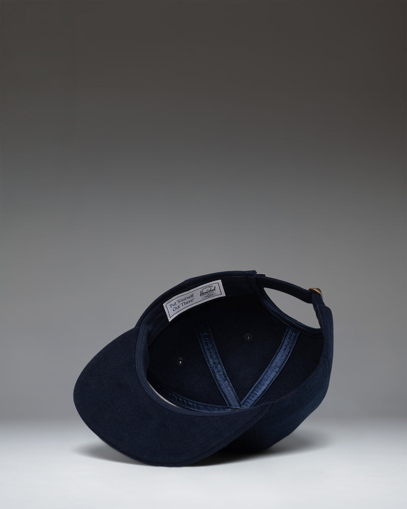 Herschel Supply Co. Scout Heritage Cap in Darkest Navy, showing a side view of the classic six-panel baseball hat with an adjustable strap.