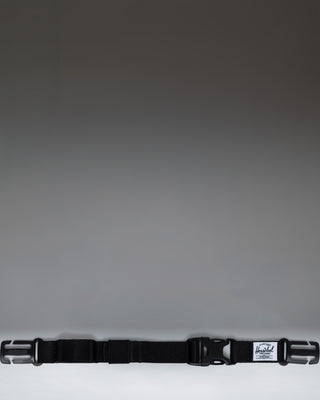Herschel Supply Co adjustable sternum strap in black, designed to attach to backpack shoulder straps for added support.