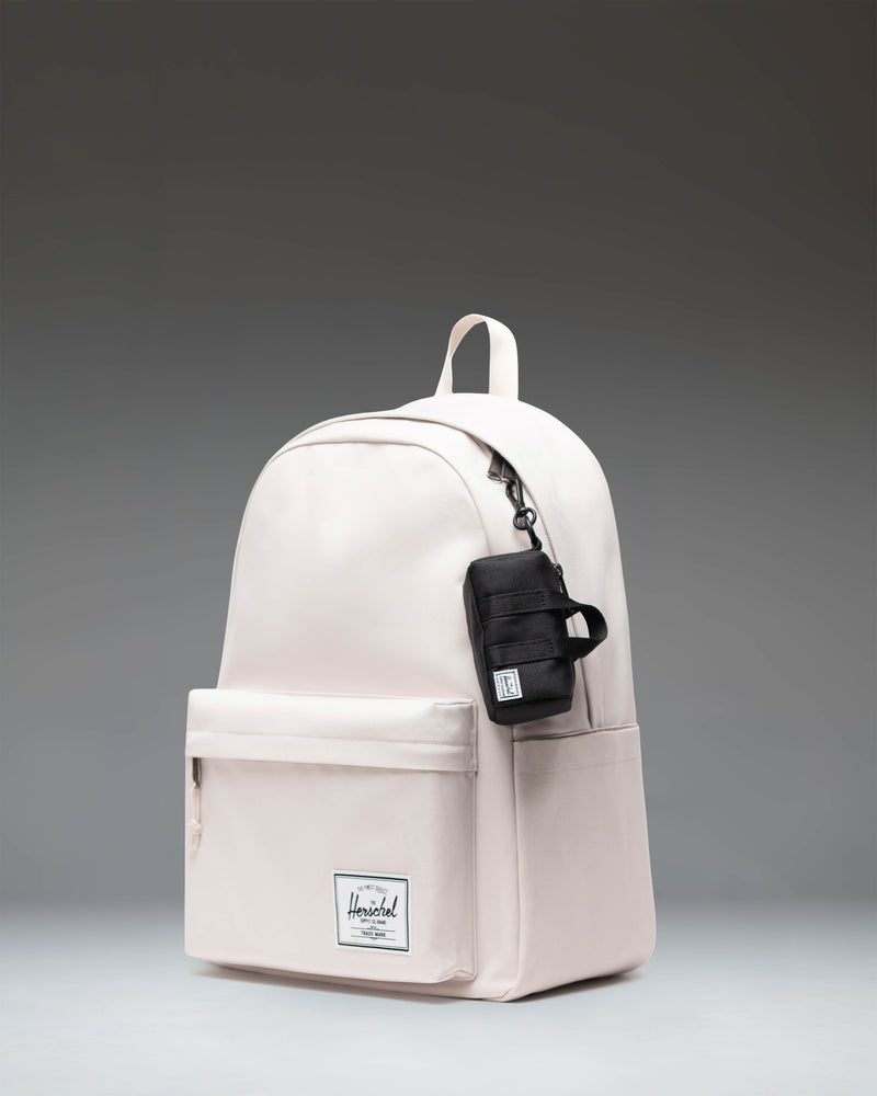 Herschel Novel Duffle Bag Charm in black, showing an over-the-shoulder view to demonstrate scale when worn.