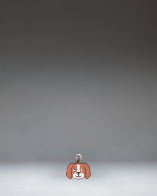 Herschel Dog Bag Charm in Brown Dog, a small plush dog accessory designed as a stylish bag charm.