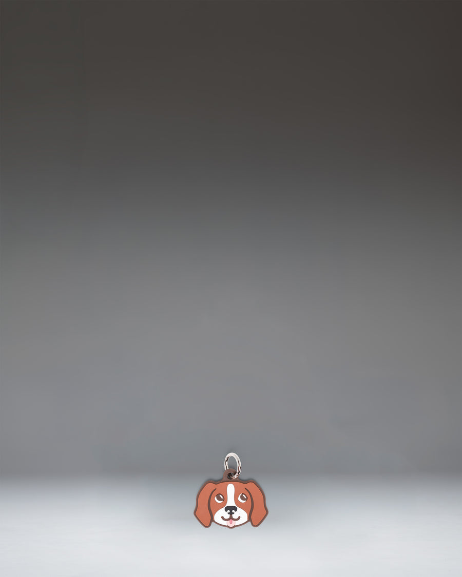 Herschel Dog Bag Charm in Brown Dog, a small plush dog accessory designed as a stylish bag charm.