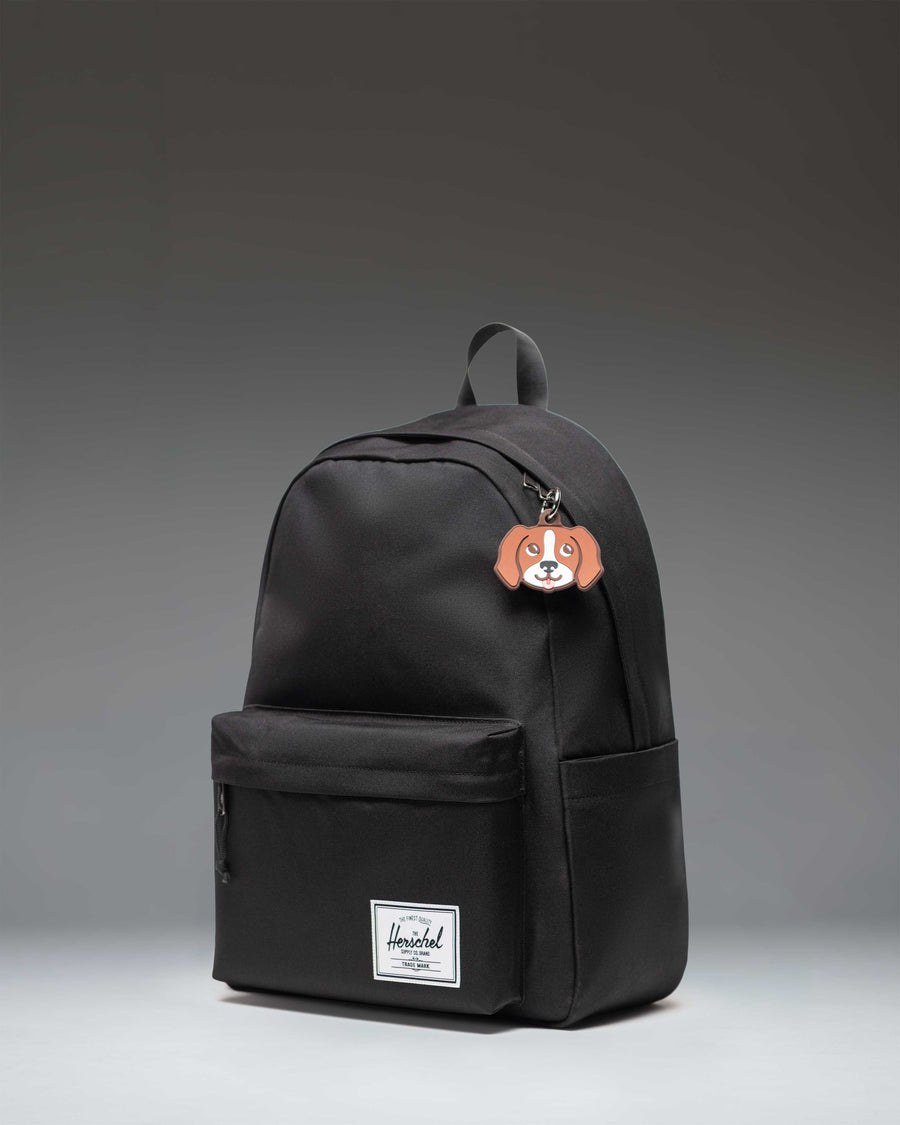 Herschel Dog Bag Charm in Brown Dog, featuring a miniature plush dog accessory designed to clip onto bags or backpacks.