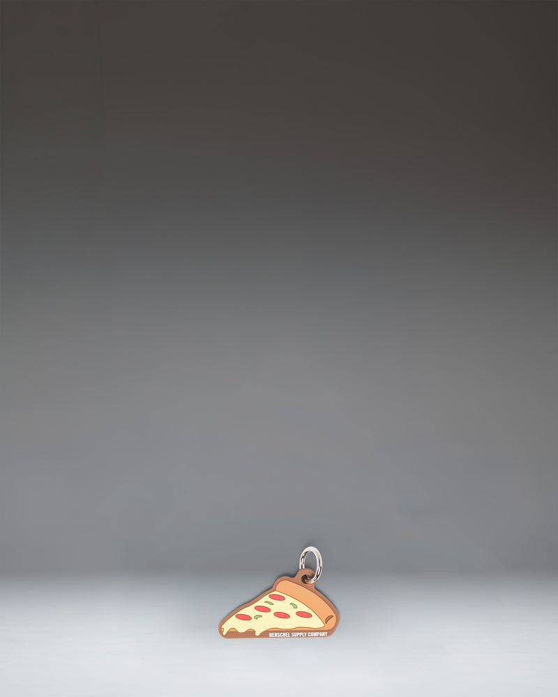 Herschel Pizza Bag Charm in Pepperoni colorway, styled like a slice of pepperoni pizza.
