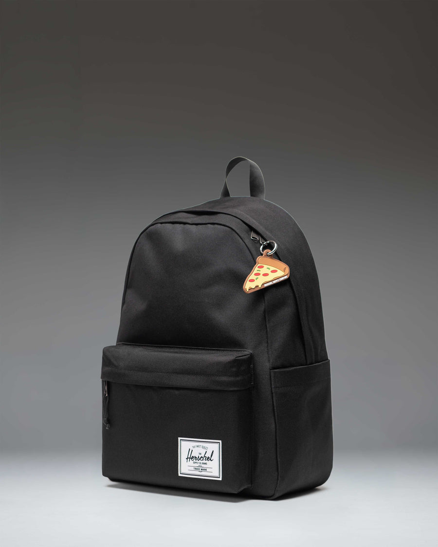 Herschel Supply Co Pizza Bag Charm in Pepperoni, a pizza slice shaped accessory attached to a backpack.