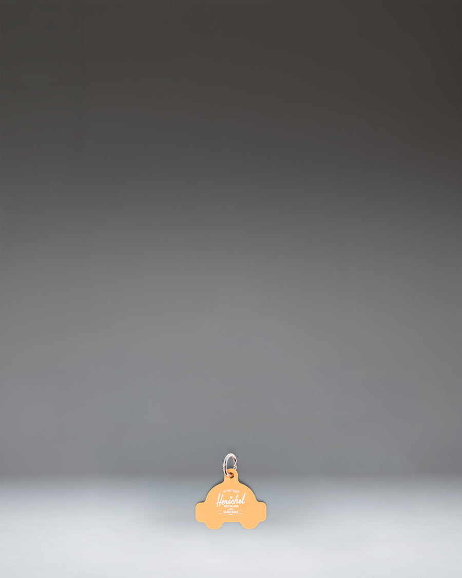 Herschel Taxi Bag Charm in Taxi yellow, resembling a classic New York City taxicab.