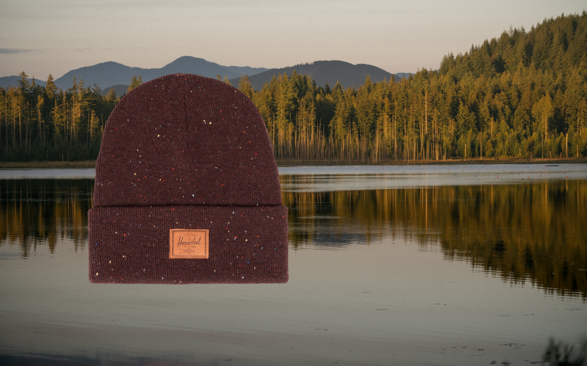 Herschel Supply Co. lifestyle product image featuring an item in Bitter Chocolate color, displayed on a desktop-optimized banner.