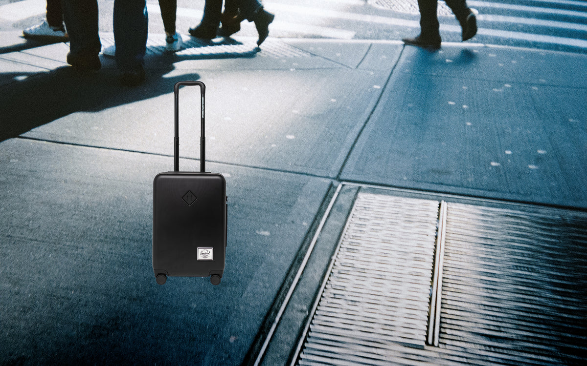Herschel Heritage Hardshell Large Carry-On Luggage in black.