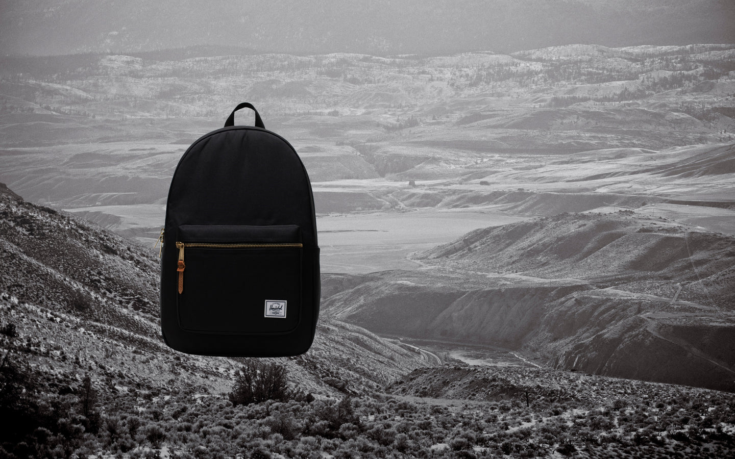 Herschel Supply Co. Black Settlement Backpack shown from the front on a plain background, highlighting its classic design and exposed zippers.