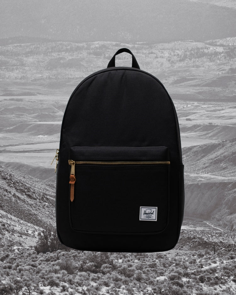 Herschel Supply Co. Settlement Backpack in black shown being worn by a model to display size and fit.