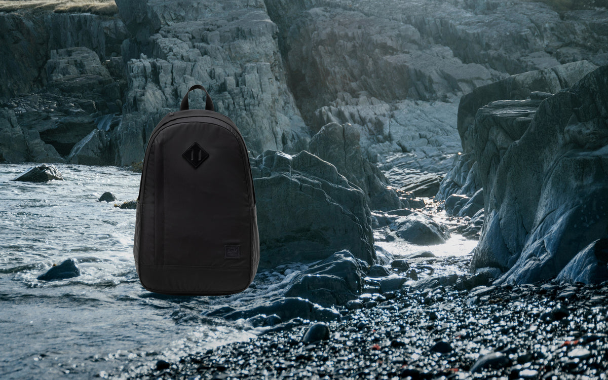 Herschel Seymour Backpack in black, shown from the front on a desktop view.