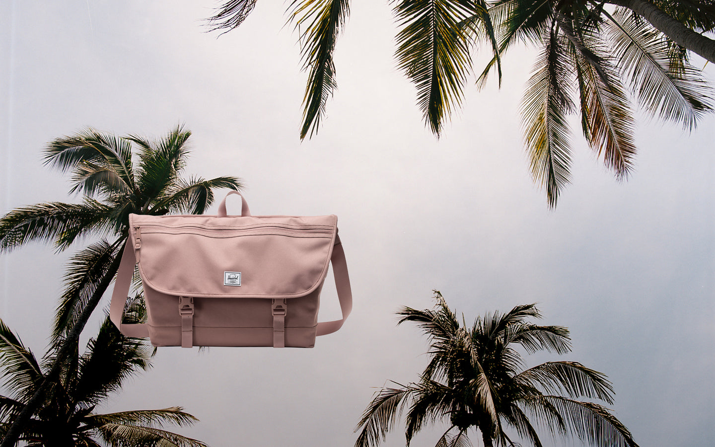 Herschel Supply Co. Cove Messenger bag in Ash Rose, shown in a desktop hero view.