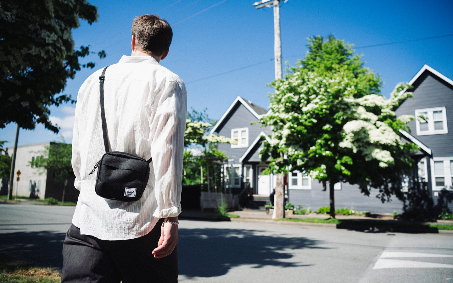 Herschel Supply Co. Classic Crossbody bag in solid black, featuring a clean, minimalist design with an adjustable strap and front zippered pocket.