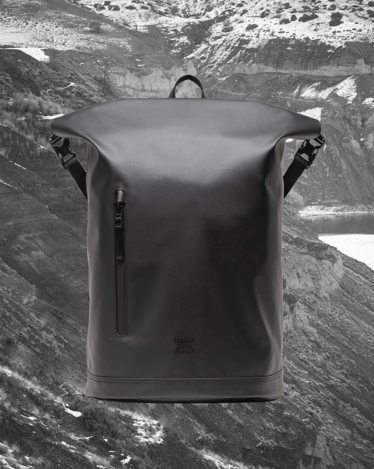 Herschel Supply Co Roll Top Backpack in black, showing the clean front design and roll-top closure.