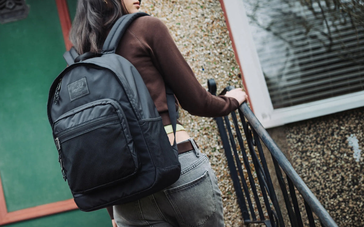 Herschel Supply Co. Kaine Backpack in solid black, showing a spacious everyday bag with multiple compartments and adjustable shoulder straps.