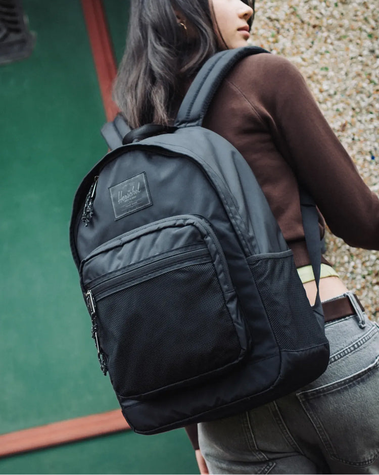 Herschel Supply Co. Kaine Backpack in solid black, a durable and spacious everyday bag featuring multiple compartments and a classic design.