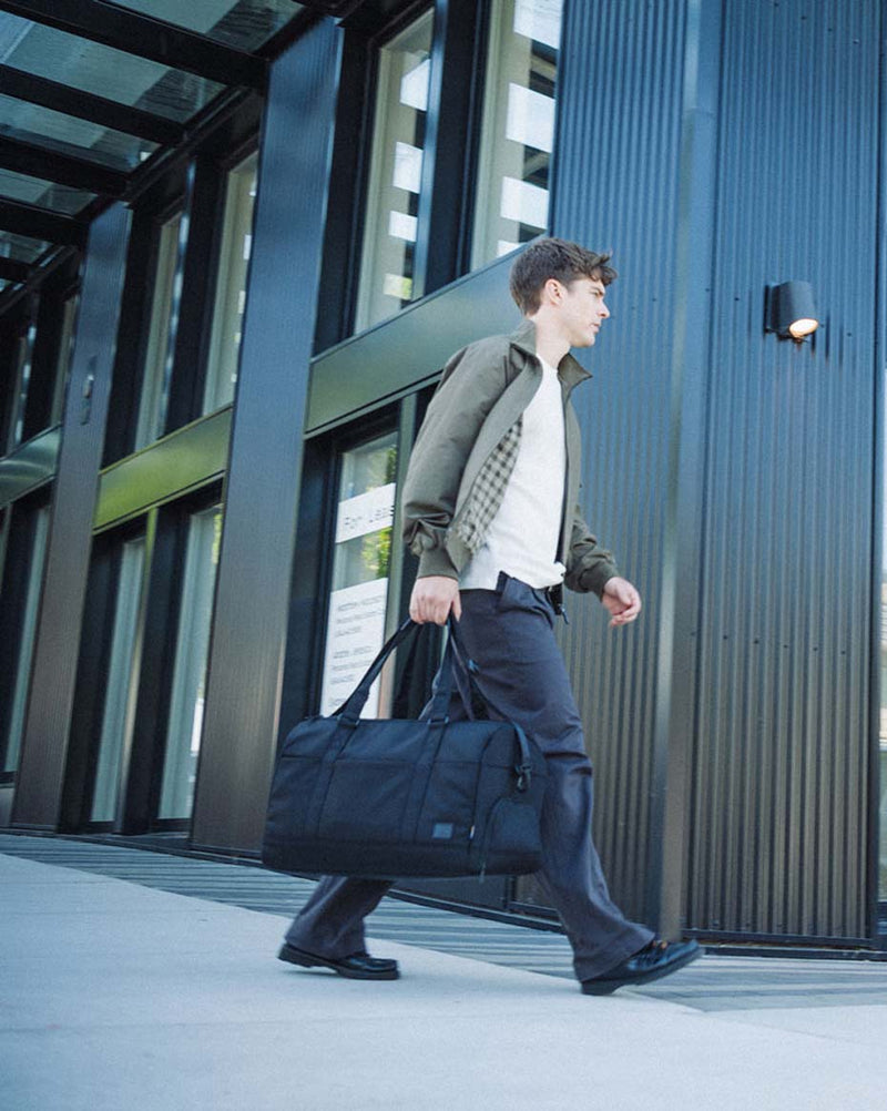 Herschel Supply Co. Novel Duffle Tech Cordura in black, a durable utility travel bag featuring premium leather trims and reinforced handles.
