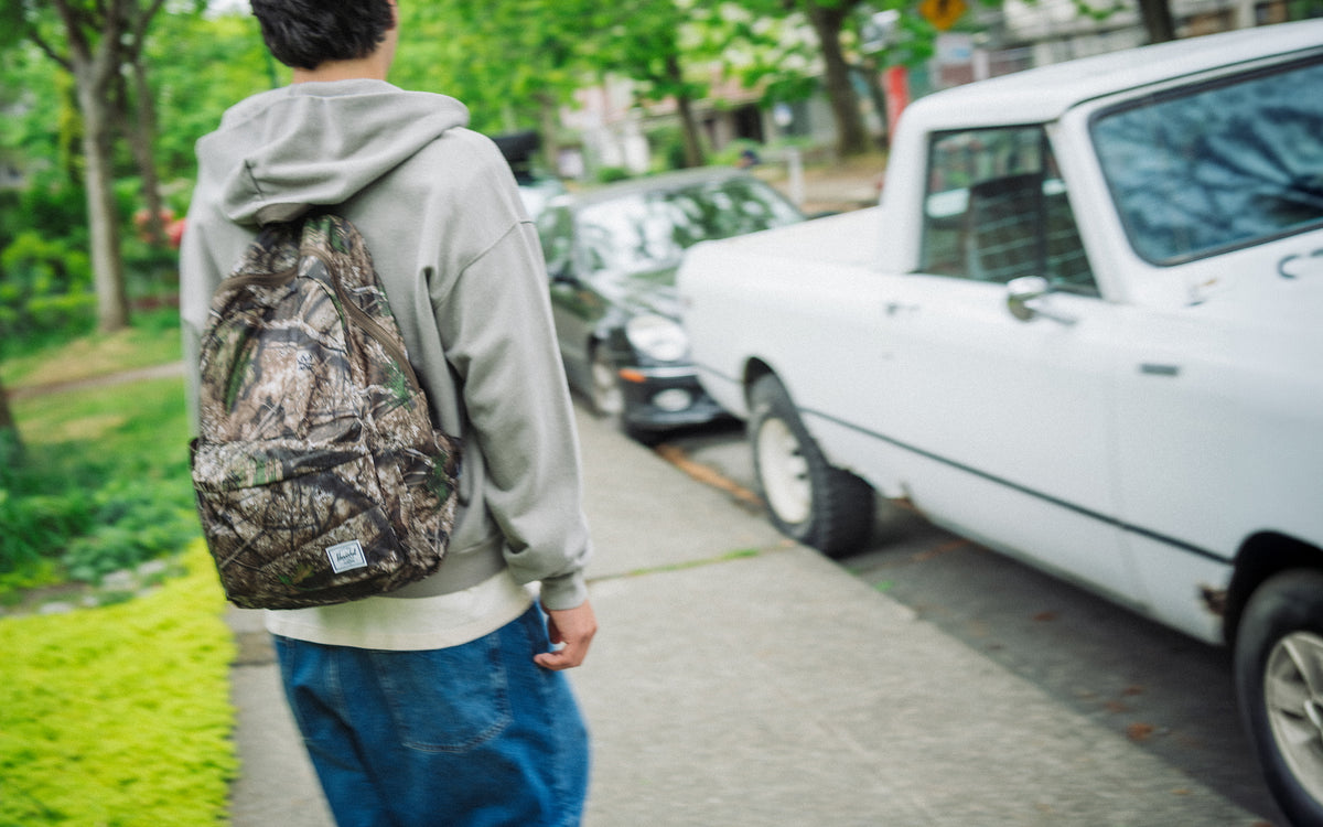 Herschel Supply Co. Realtree Rome Packable Backpack in the Realtree APX Camo pattern, displayed as a hero image for desktop.