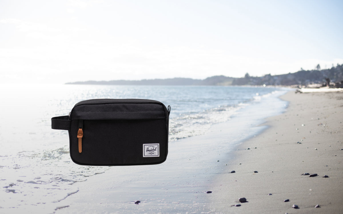Herschel Supply Co. Chapter Travel Kit in black, a compact toiletry bag featuring a convenient side carrying handle.