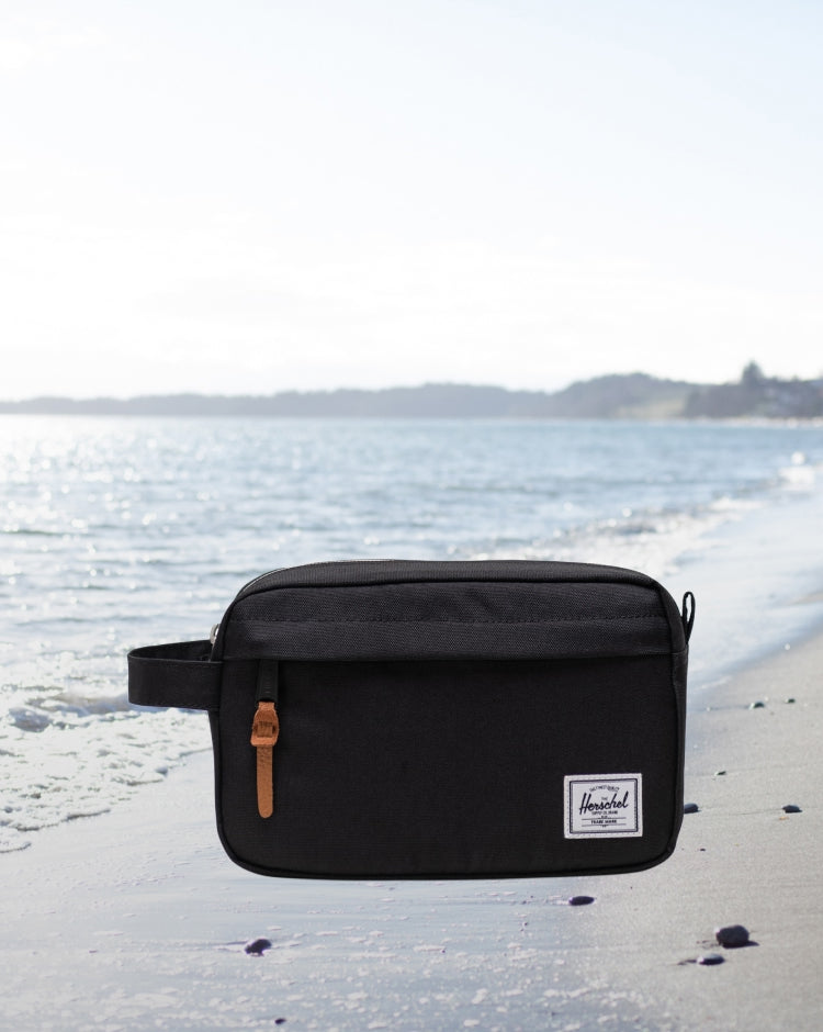 Herschel Supply Co. Chapter Travel Kit in solid black featuring a waterproof zippered closure and a convenient side carrying handle.