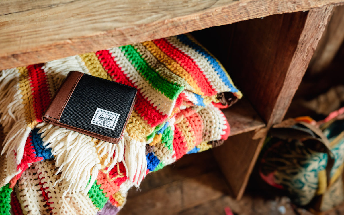 Herschel Supply Co Hank Wallet in Black/Tan, showcasing its classic bifold design.