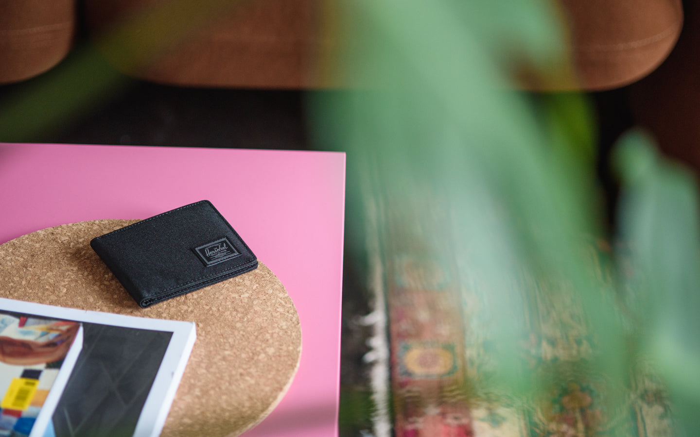 Herschel Supply Co. Roy Wallet in Black Tonal displayed on a desktop background.
