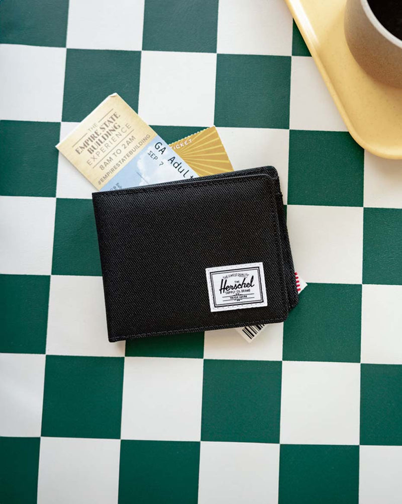 Herschel Supply Co. Roy Coin Wallet in classic black, showcasing its compact bifold design.