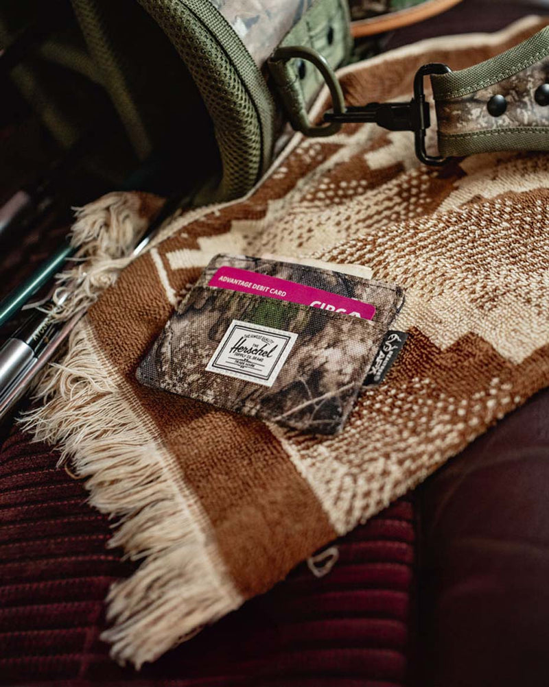 Herschel Supply Co. Realtree Charlie Cardholder in Realtree APX Camo pattern featuring multiple card slots and a slim design.