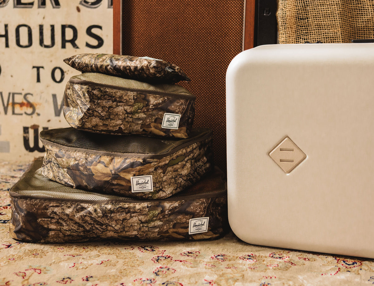 Herschel Supply Co. Realtree Kyoto Packing Cubes featuring the Realtree APX Camo pattern.
