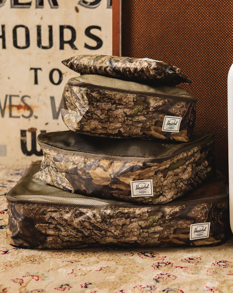 Herschel Supply Co. Realtree Kyoto Packing Cubes in the Realtree APX camouflage pattern.