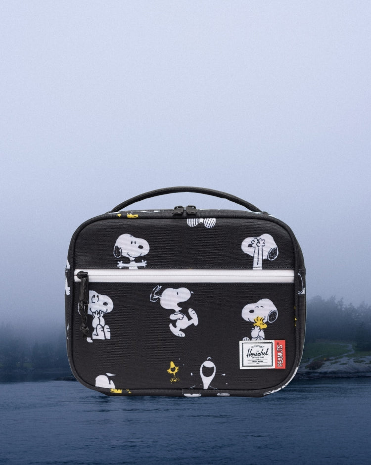 Herschel Supply Co. Peanuts Pop Quiz Lunch Box in Snoopy and Woodstock Black featuring a repeating pattern of the iconic characters.