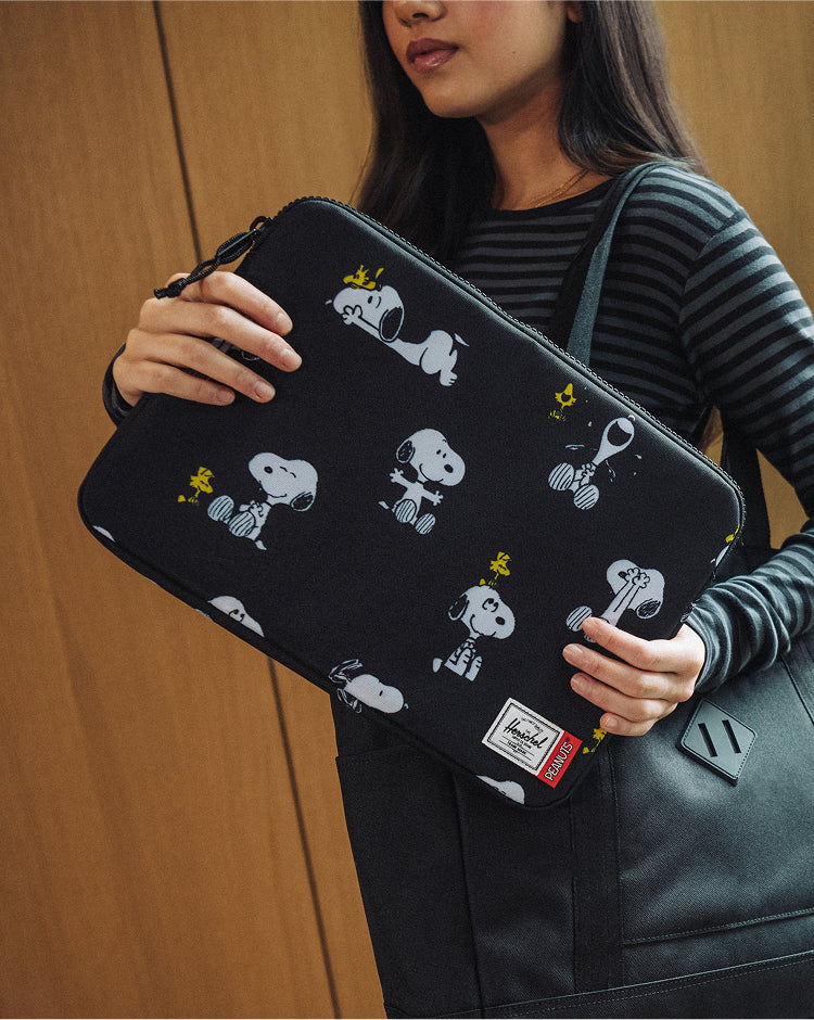 Herschel Supply Co. Peanuts Anchor 14 Inch laptop sleeve in Snoopy and Woodstock Black.