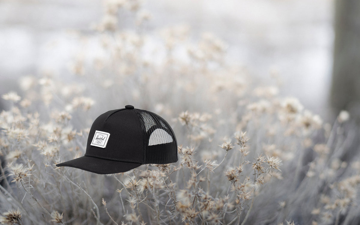 Herschel Supply Co. Whaler Cotton Mesh Baby Cap for ages 6-18 months in black.