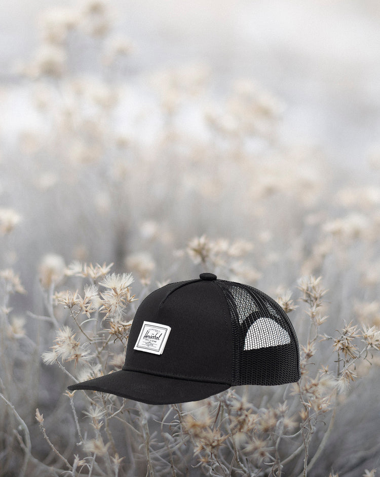Herschel Supply Co. Whaler Cotton Mesh Baby Cap for 6-18 months in black, showing the front view of the mesh trucker-style hat.