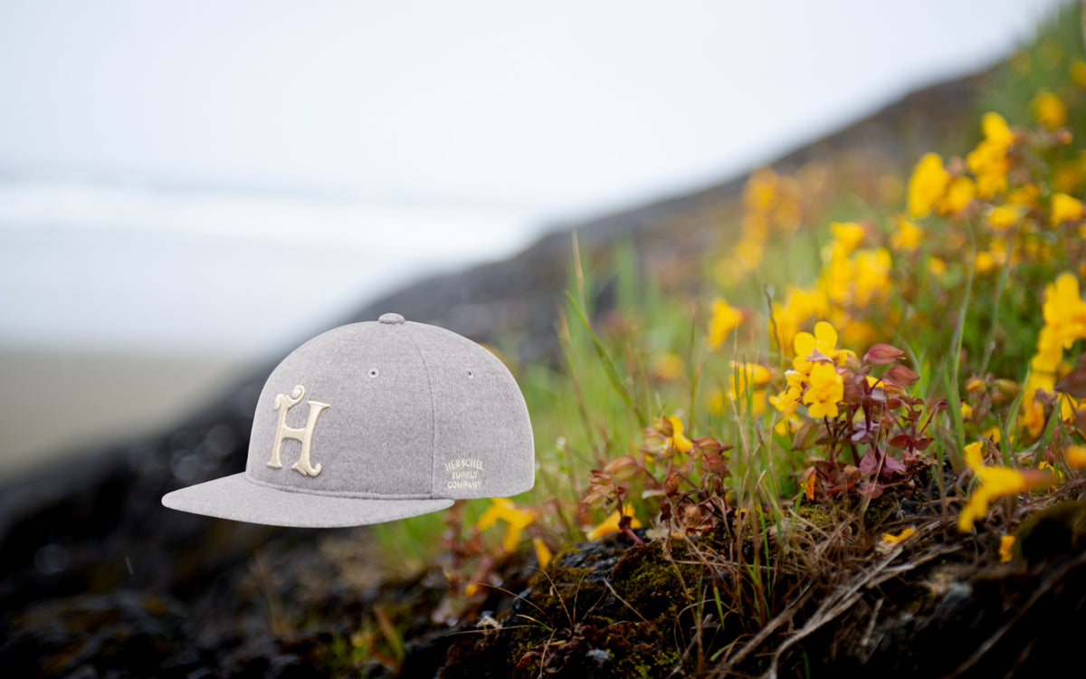 Herschel Supply Co Vintage Baseball Cap in Heather Light Grey on a desktop banner.