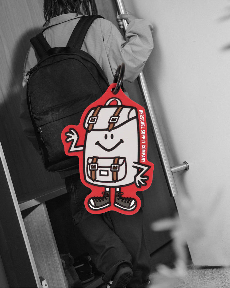 Herschel Supply Co. Sam Bag Charm Little Herschel in Tango Red, a miniature backpack keychain accessory.